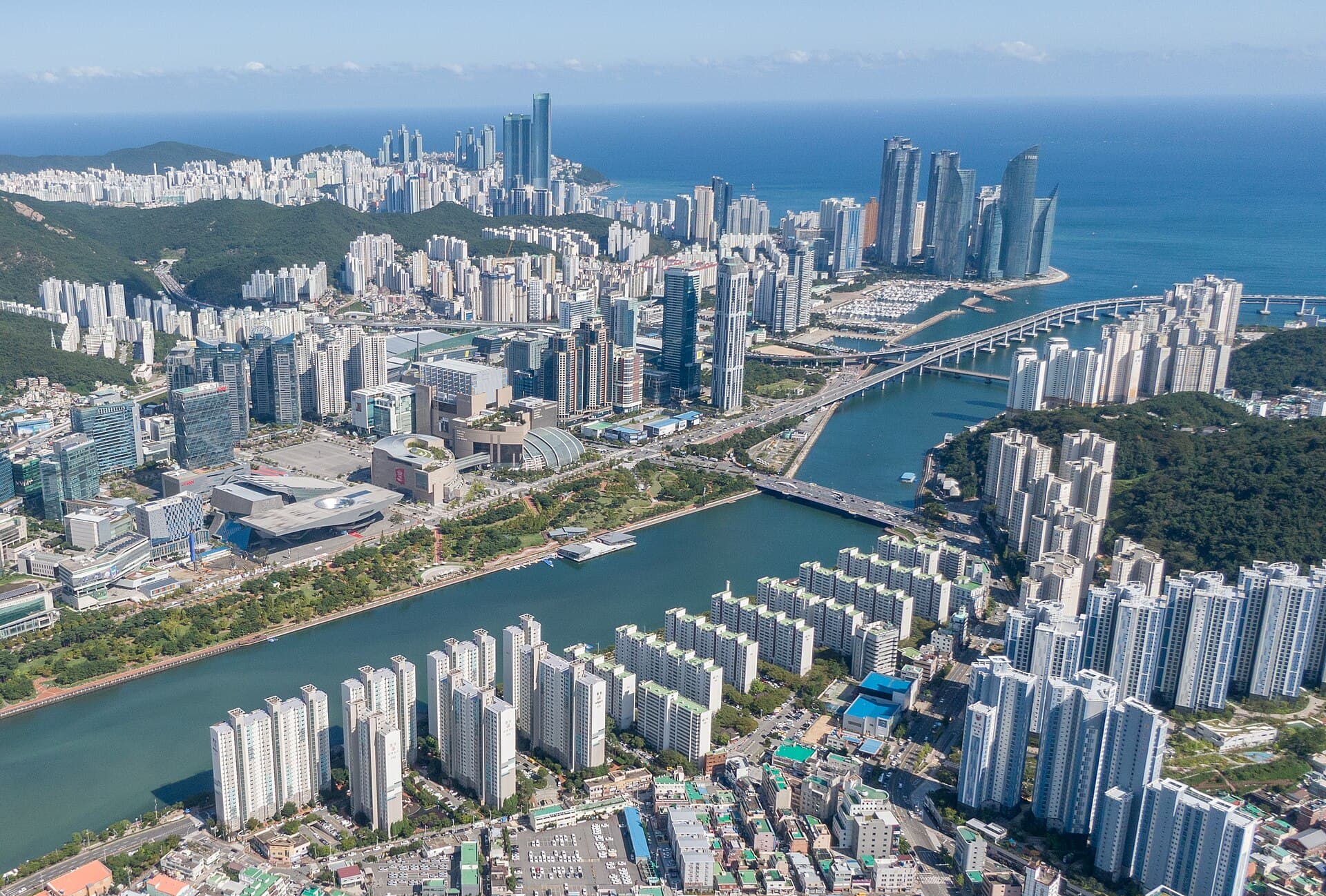 Busan coastline, marina, and city towers around Haeundae